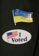 MP badge and badge with the words "I voted"