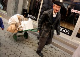 A man carries a cart firewood