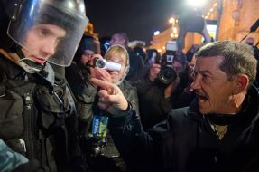 Participant of the meeting speaks with fighters of special "Berkut"