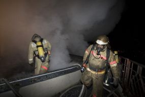 Firefighters in fire extinguishing place