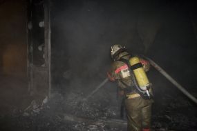 Firefighters in fire extinguishing place