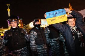 A man holds a banner