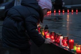 The girl puts a candle 