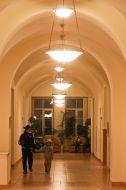 Woman with child walk down a corridor