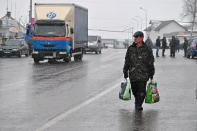 A man carries bags through the checkpoint
