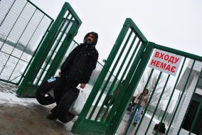 A man carries tires across the border