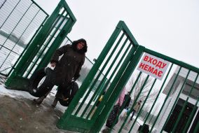A woman carries tires across the border