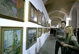 Visitors examine pictures