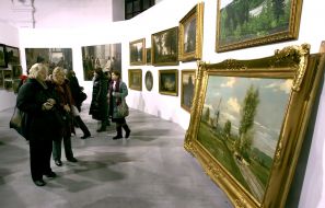 Visitors examine pictures