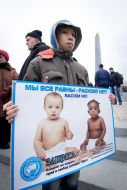 A boy holds a placard