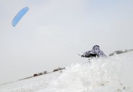 Skier riding a kite