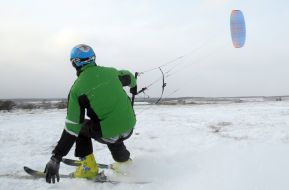 Skier riding a kite