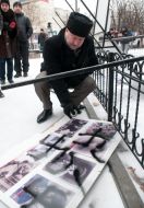 A man paints a swastika