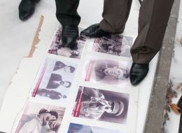 Men stand at the booth with photos