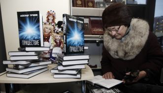 A woman reads a book by Aleksandr Turchinov "Advent"