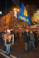 A girl carries a portrait of Stepan Bandera