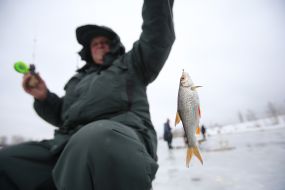 A fisherman shows fish