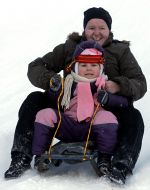 Woman with child sledding