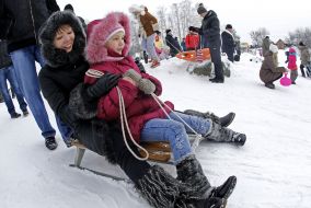 Woman with child sledding