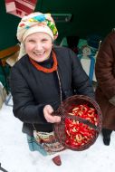 A woman holds a basket of bagels