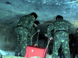 Soldiers lowered the coffin into the grave