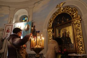 Woman lighting a candle