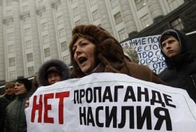 Participant of the action of protest holding a poster