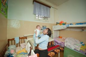 A woman is holding a baby