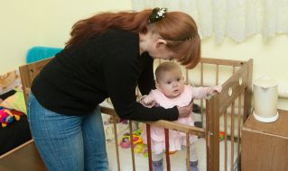 A woman is holding a baby