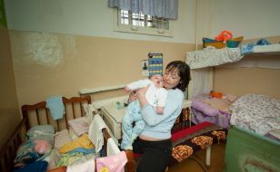 A woman is holding a baby