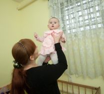 A woman is holding a baby