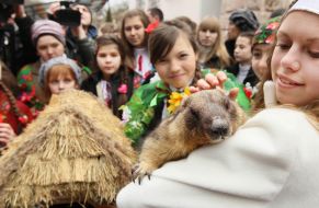 A girl holds a marmot