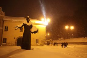 Passersby are on a snowy street