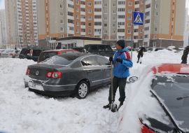 A man digs out his car