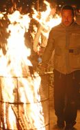A man walk near the fire