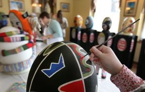 The artist paints pysanka