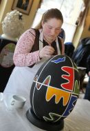 The artist paints pysanka
