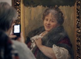 A visitor photographs the picture