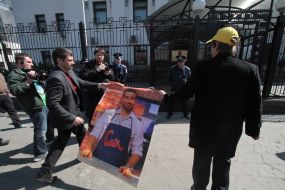 A man holds a poster featuring  Ivan Urganta