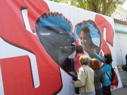 Residents of Sevastopol hang a poster