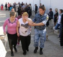 Police officer leading victim woman