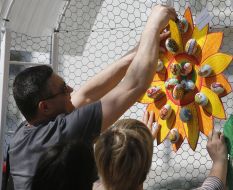 Man decorates flower pysankas