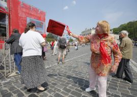 Communist supporter brandishing a package on a woman-nationalist
