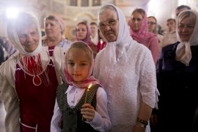 A girl holds a candle