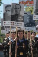 Participants of parade holding portraits of heroes of the Soviet Union