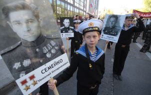 Participants of parade holding portraits of heroes of the Soviet Union