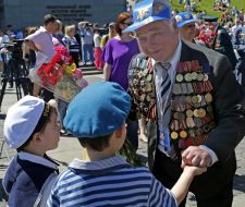 The boys handed flowers to veteran