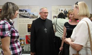 A visitor views paintings