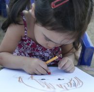 Girl paints a portrait of mother