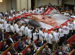 The deputies hold a poster with a picture of Yulia Tymoshenko